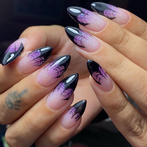 purple and black halloween nails with spider web
