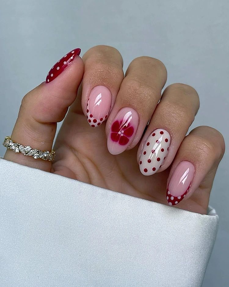 red floral spring nail design with polka dots and glossy short nails