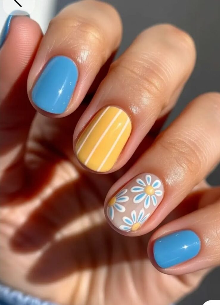 short spring nail ideas in bright colors like blue and yellow with daisies
